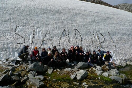 Kinder vor "Stand Up"-Schriftzug in Norwegen auf Outward Bound 