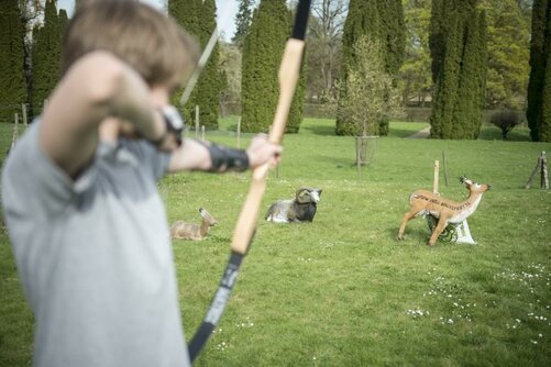 Students doing archery on the castle grounds in Salem.