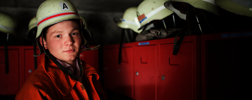 Junge beim Feuerwehrdienst 